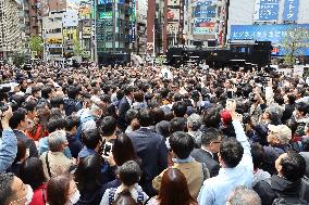Crowds of people looking for the newspaper announcing the decision on the new era name, "2045.